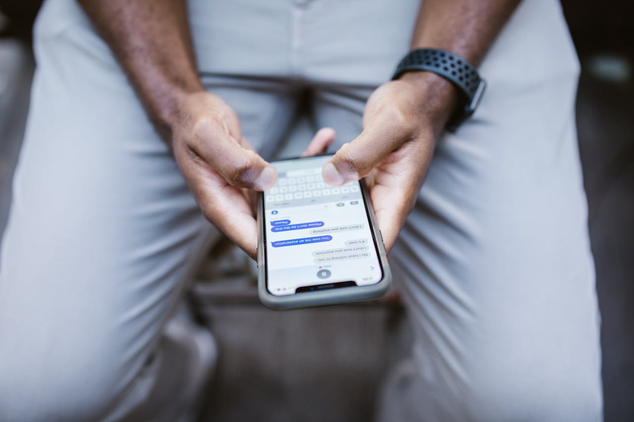 Close-up view of a man texting on a smartphone, capturing communication in action.